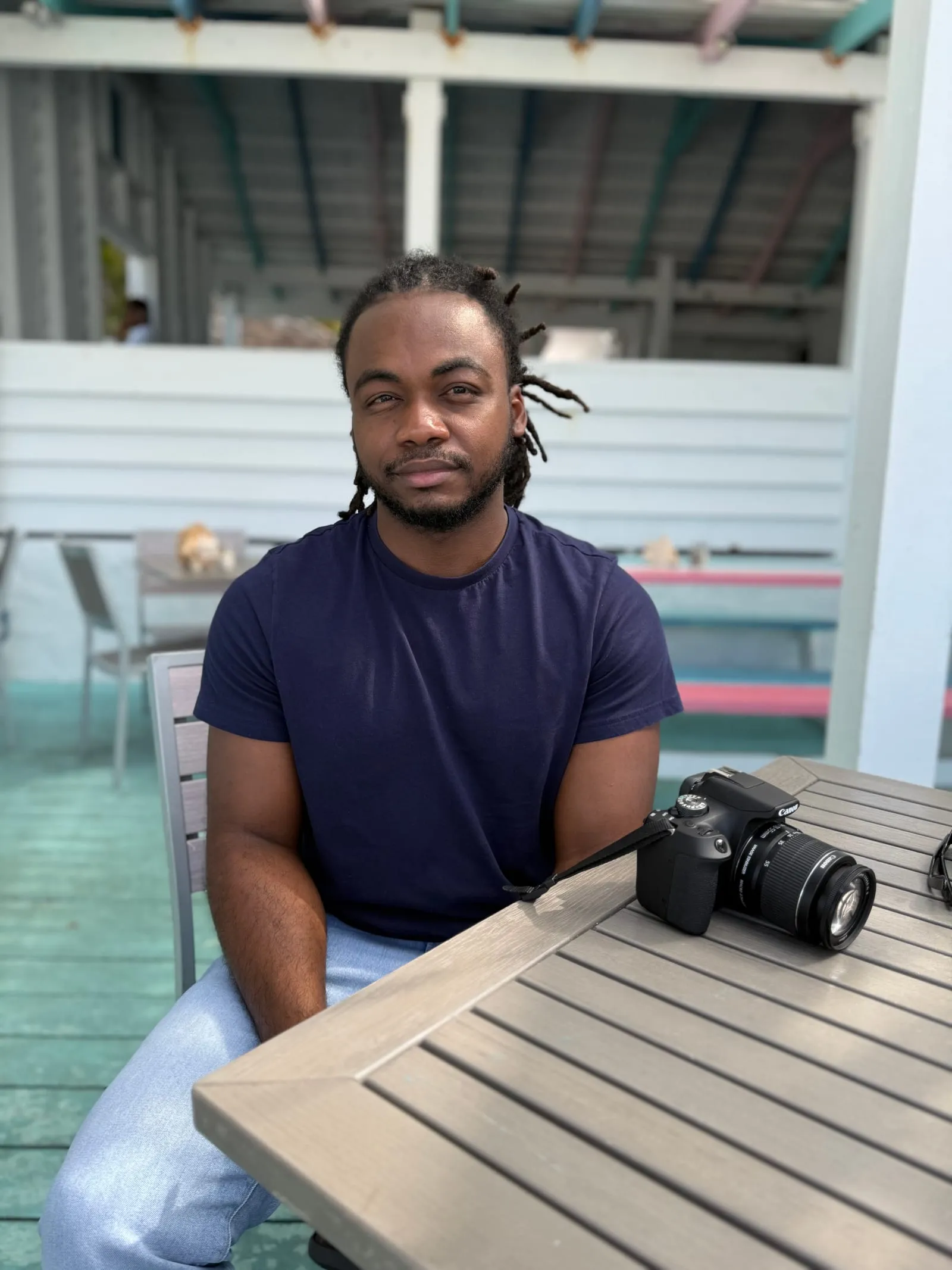Marvin at an outdoor table in Providenciales, his camera beside him